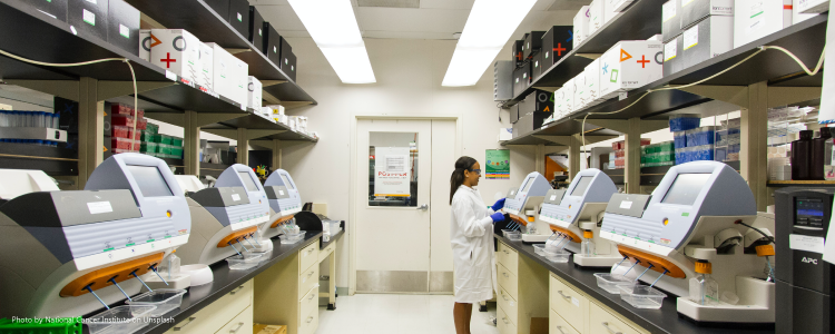 pathologist preparing a sample for microscopic examination in a hospital lab