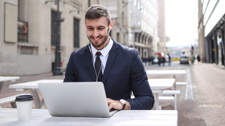 Man in Black Suit Jacket Using Laptop