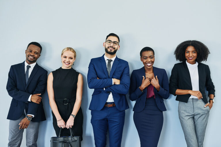 diverse group of businesspeople standing and smiling while waiting in line for an interview