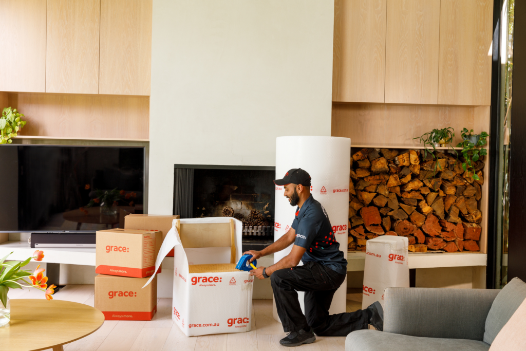 Removalist packing moving boxes.