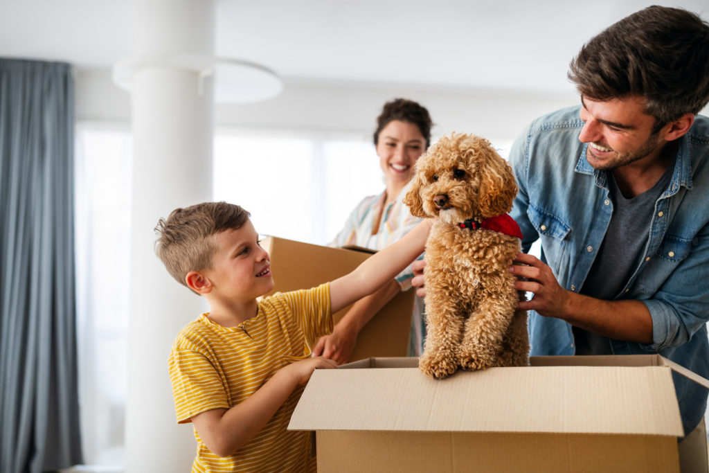 Family unpacking moving boxes