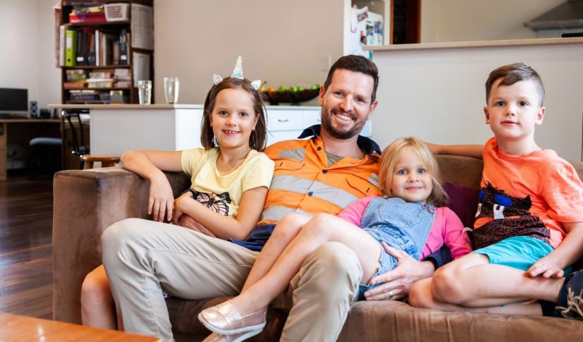 happy father with his children sitting on the sofa Property Company Owned