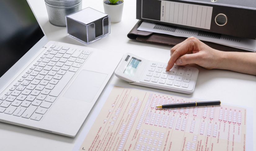 View of woman completing Australian tax form Taxation Advice