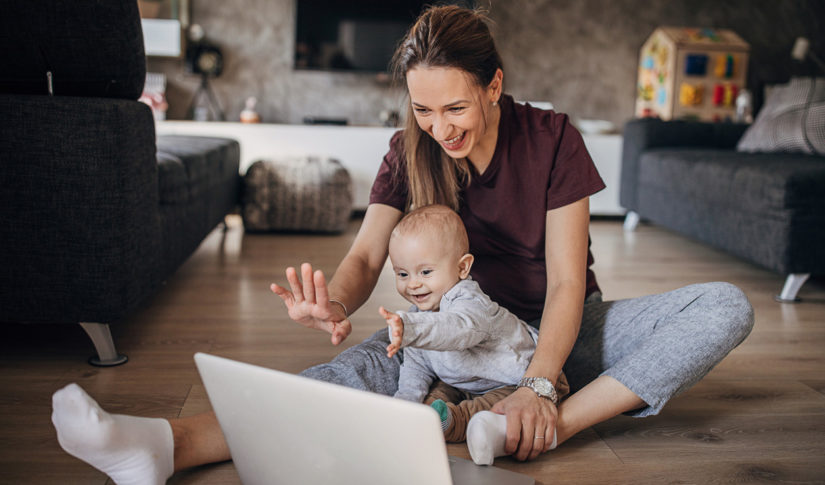 Beautiful mother and her baby son talking with family on the video call Housing Differentials